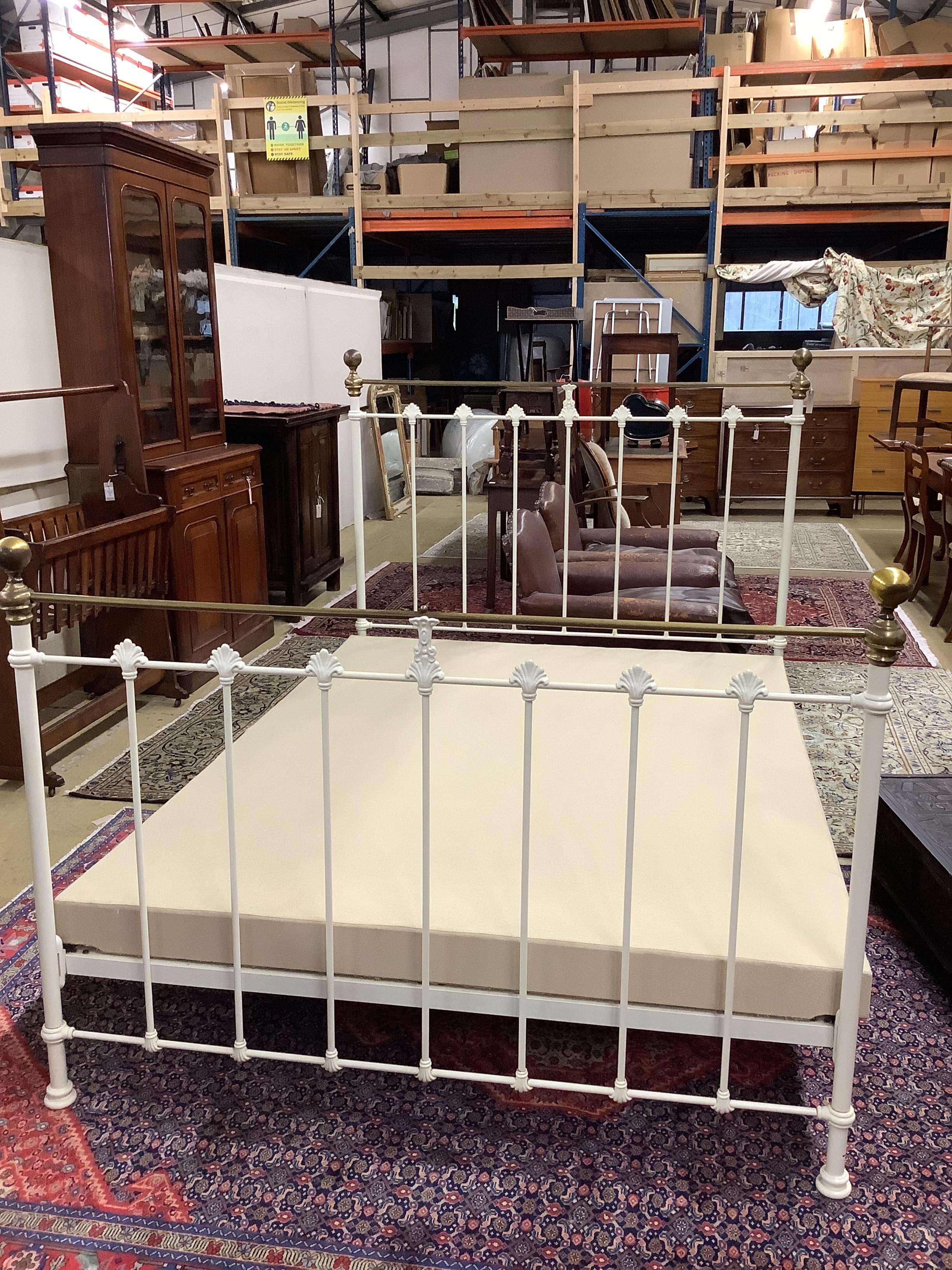 A Victorian style brass mounted painted metal double bed frame, width 150cm, length 208cm, height 142cm